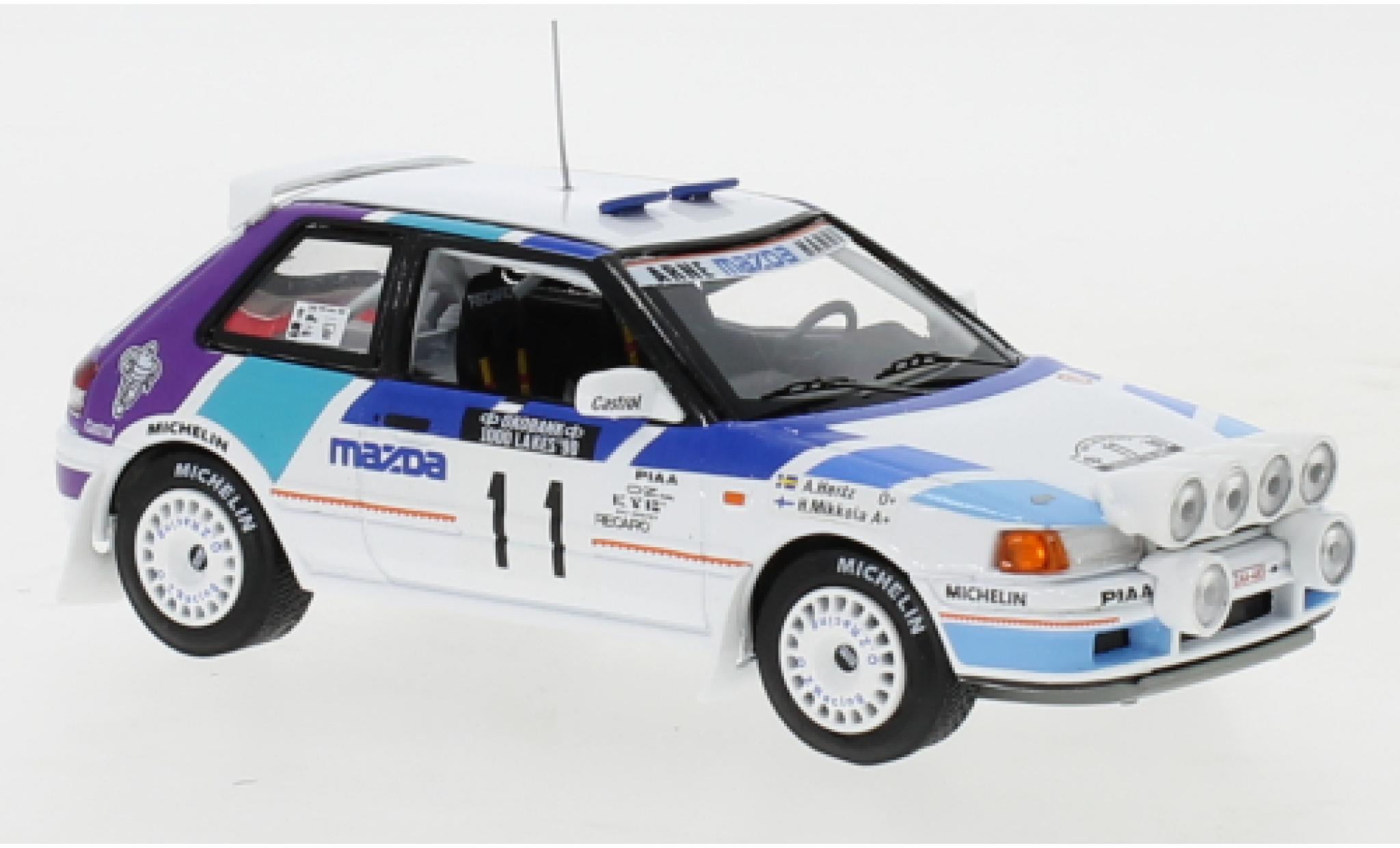 Mazda 323 1/43 IXO GTX No.11 Rally Team Europe 1000 Lakes Rallye 1990 with night lights H.Mikkola/A.Hertz modelauto