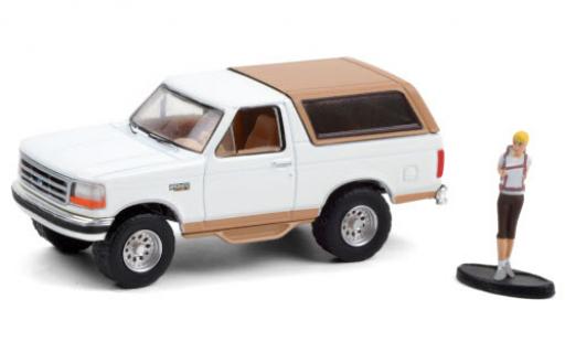 Modelauto Ford Bronco Eddie Bauer wit/mat-beige 1996 avec figurine 1/64 Greenlight